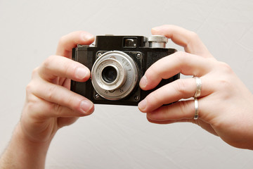 Fototapeta premium hands holding an old camera
