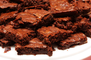 A plate piled full of brownies,