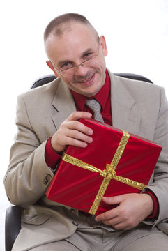 The man holds a gift in hands