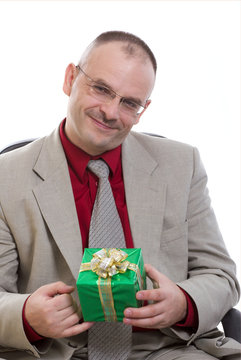 The man holds a gift in hands