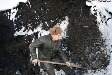The working man handles the coal in winter
