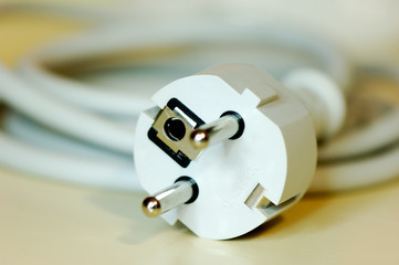 Close-up shot of a european plug connected to a long cable  - 5934474