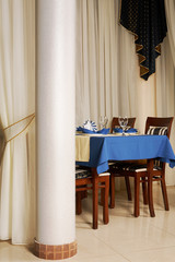 Table with a blue tablecloth at modern restaurant
