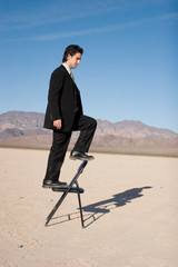 Businessman climbing up the corporate ladder