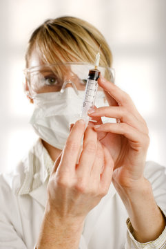 young women doctor with injection in a laboratory close up