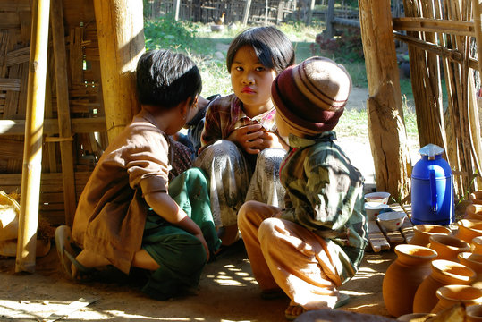 asian children in wooden house