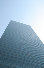 A lone building dominating the skylines of a blue sky.