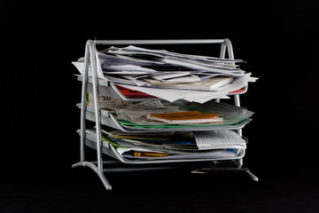 Messy in-basket with papers