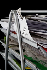 Messy in-basket with papers
