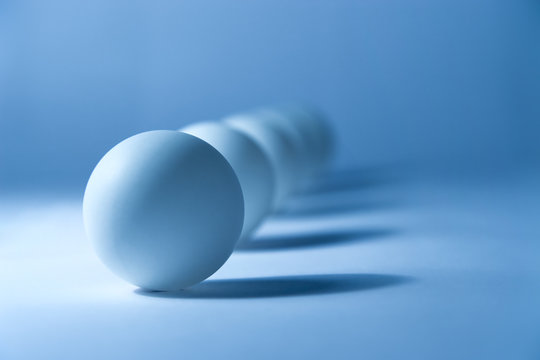 Abstract still life with small balls. Soft blue tint.