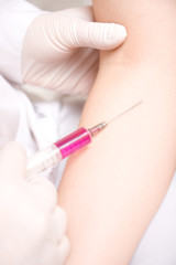 Close-up vaccination procedure in hand. Injection in to hand.