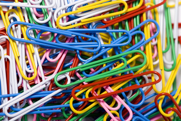 A close up of colorful paperclips in an office