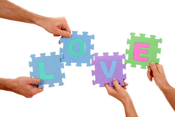 hands holding puzzle with love letters isolated on white