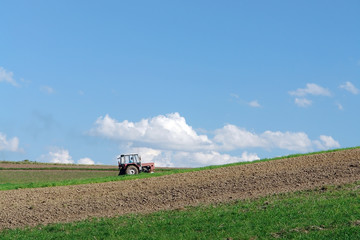Farm tractor plowing arable field