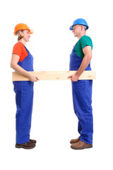 Female and male builders holding plank