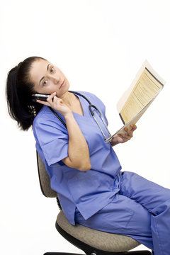 Pretty Nurse Isolated On White On Phone With File Folder