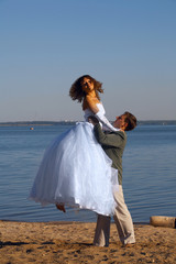 Fototapeta na wymiar Bride and fiance on the beach