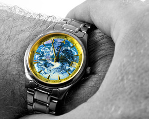 Watch with Earth face, showing time 11:55