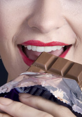 Closeup of chocolate eating woman