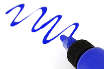 A blue paint bottle with paint strokes