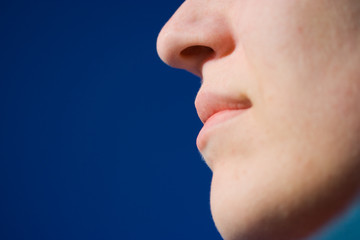 Part of face on blue sky