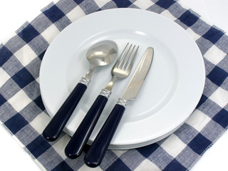 served table plates fork spoon knife and serviette