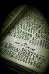 antique holy bible open to the book of daniel 