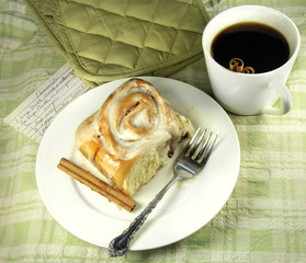 Cinnamon Roll with coffee and a fork.