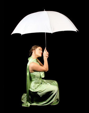 elegant young woman sitting wih white umbrella