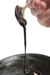 Drops of chocolate on the spoon and a plate
