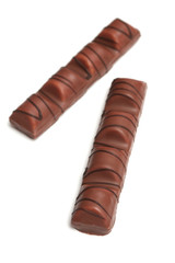 Tasty chocolate lays on a white background