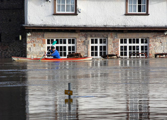 Canoeist paddles past flooded pub. River Ouse, York, UK. - 5992466