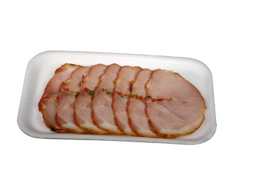 Slices of a ham with spices isolated on a white background