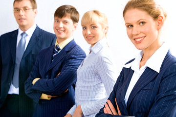 Portrait of business team in row with female leader in front