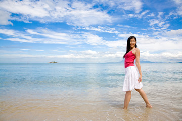 Fototapeta na wymiar young girl standing by the beach turn back and look
