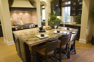 Luxury home kitchen with a granite island.
