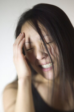 Young Asian woman with a headache
