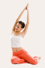 Fototapeta premium young woman doing stretching exercise on the floor