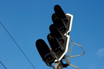 Railway traffic signal light against clear blue sky