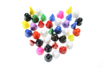 Game Pegs Arranged in Shape of Heart on White Background