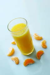 Orange juice surround by clementine pieces