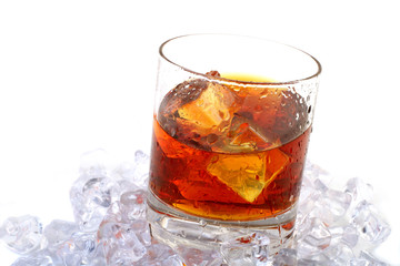 glass of whiskey with ice cubes on white background