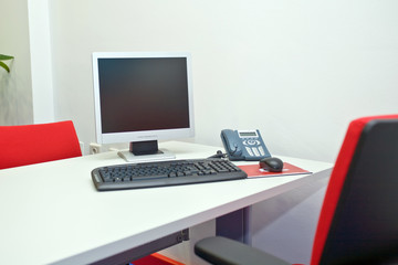 moderm office desk with pc phone and keyboard