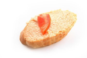 On a photo a sandwich with caviar and a tomato. It is isolated