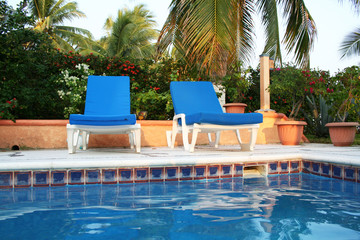 Luxury tropical pool with lounge chairs