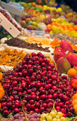 A street market with a range of fruits for sale.