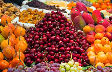 Naklejka na ściany i meble A street market with a range of fruits for sale. 