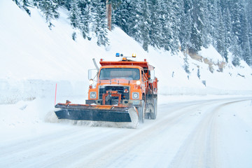 Fototapeta premium Snow plow removing snow from mountain highway