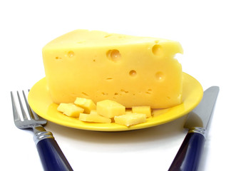 Cheese on the plate served with fork and knife for eating