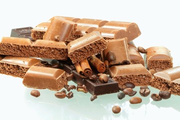Chocolate and spices on white background